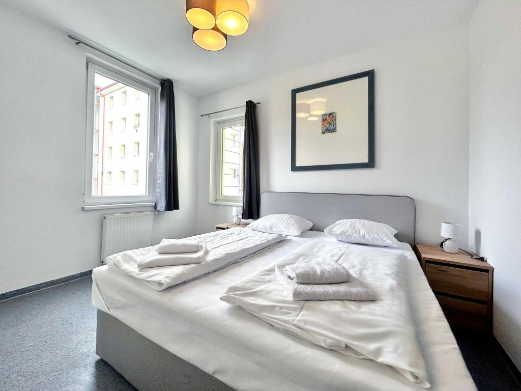 a bedroom with a large white bed with two towels on it at Hotel Astral Vienna in Vienna