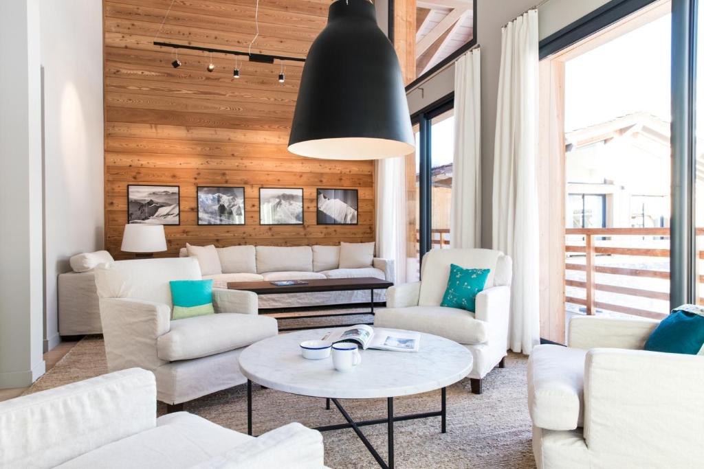 a living room with white furniture and a black ceiling at La Cordee 331 Apartment in Chamonix-Mont-Blanc