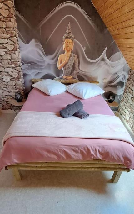 une statue d'une femme assise sur un lit dans l'établissement Cottage La loge, à Huisnes-sur-Mer
