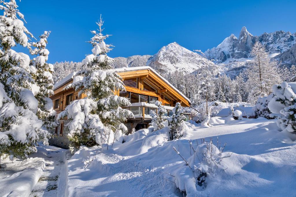 a log cabin in the mountains covered in snow at Chalet Black Stone in Chamonix-Mont-Blanc