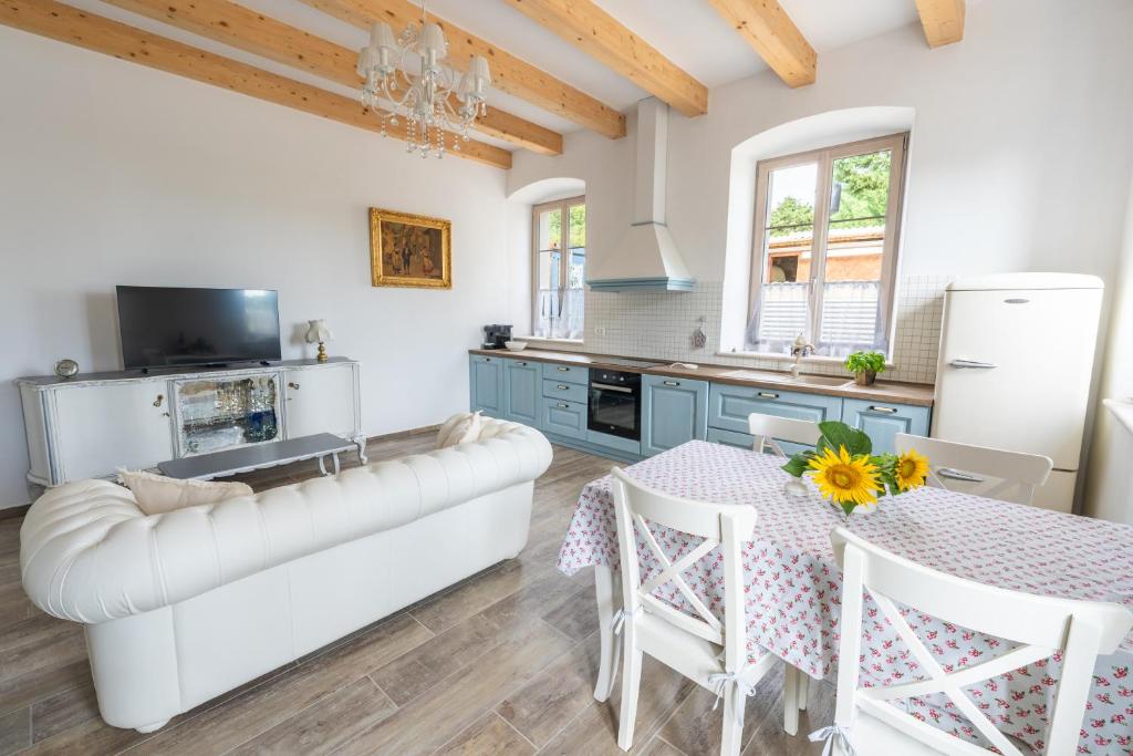 a kitchen and dining room with a table and a couch at Amalija Apartments in Strunjan