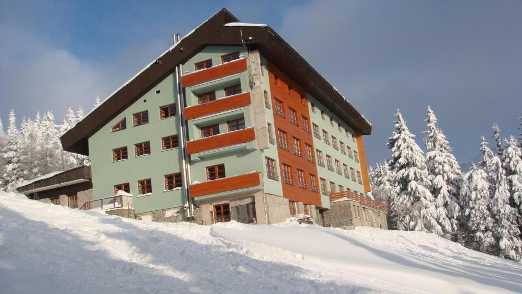 a building on top of a snow covered slope at Studio na horách in Cerny Dul