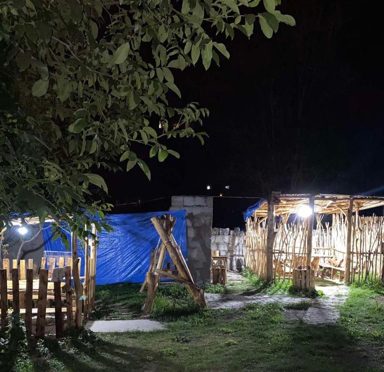 una cerca de madera por la noche con una lona azul en Sevan Hotel, en Sevan