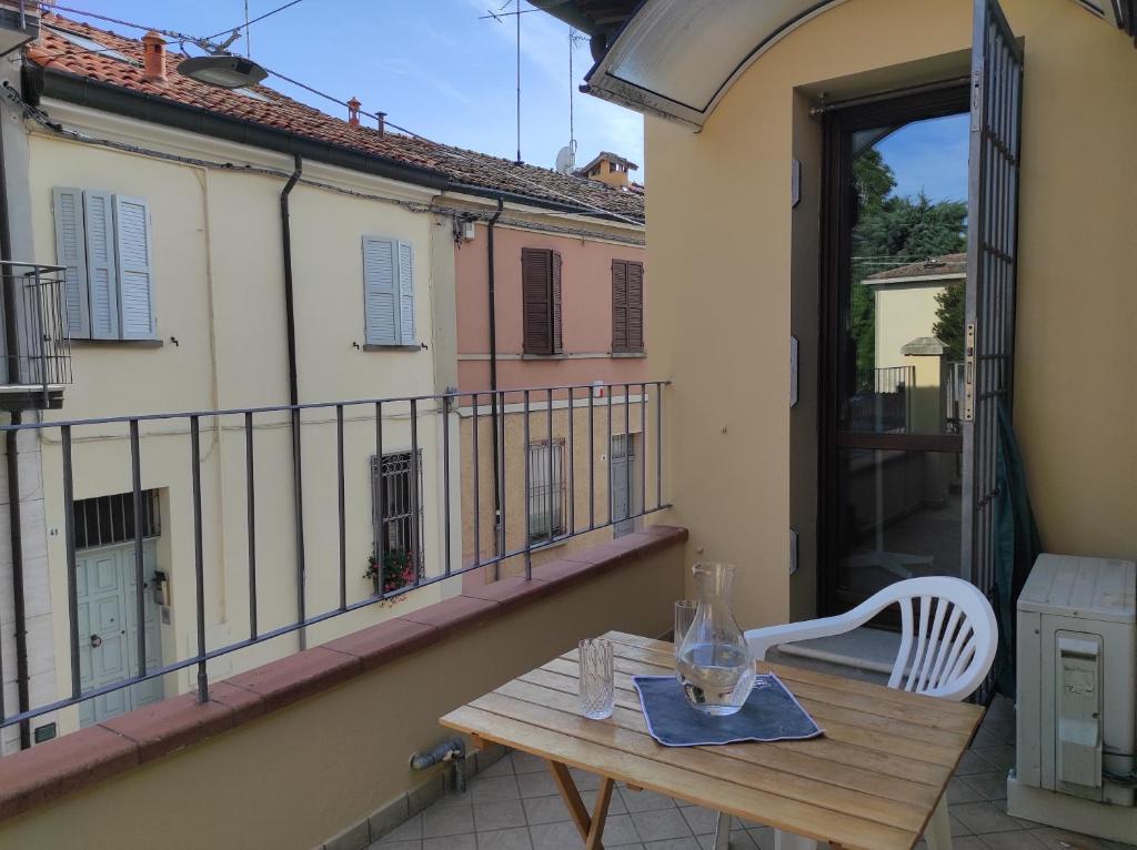 a wooden table and a chair on a balcony at Via Zagarelli alle Mura 80 in Ravenna