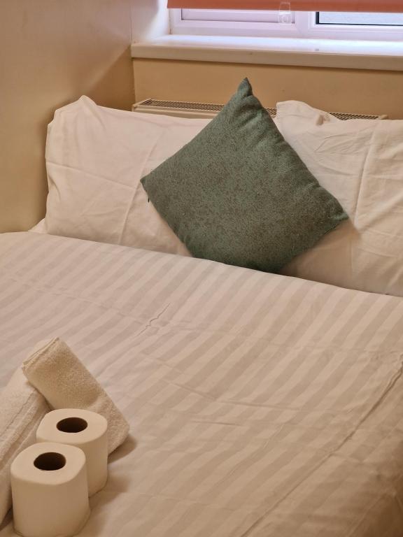 a bed with two pillows and two towels on it at Beautiful 1 room House in London in London