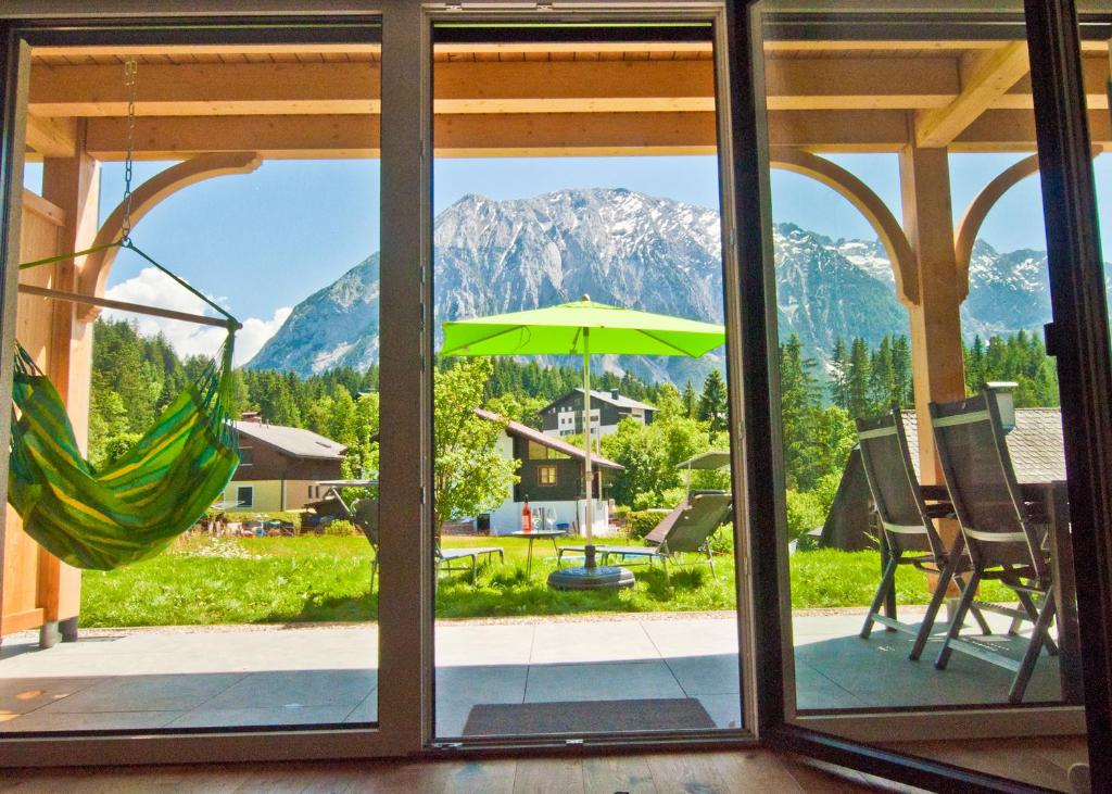 a view from a window of a patio with an umbrella at Appartement Grimminggarten in Tauplitz