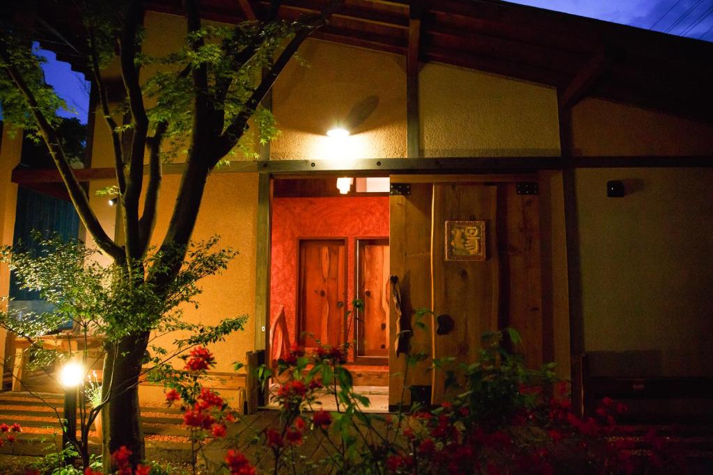 a house with a light on the door at night at Nikko Akarinoyado Villa Revage in Nikko