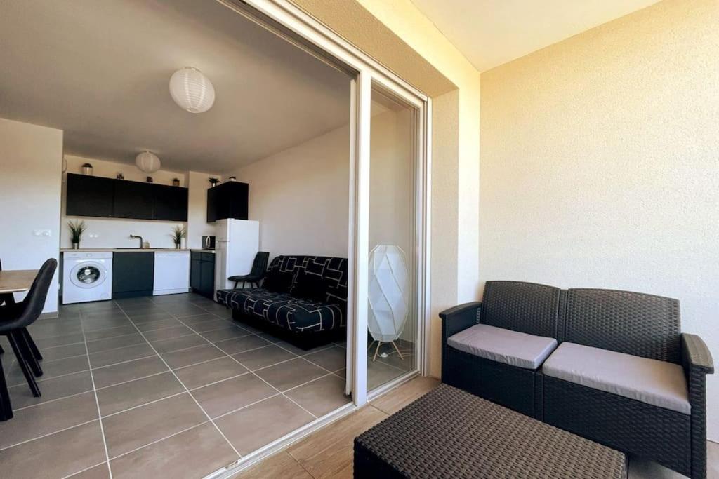 a living room with a couch and a kitchen at Esprit du Sud - Terrasse & Parking in Brignoles