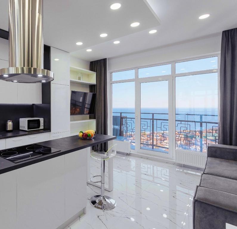 a white kitchen with a view of the ocean at Sea Pearl in Odesa
