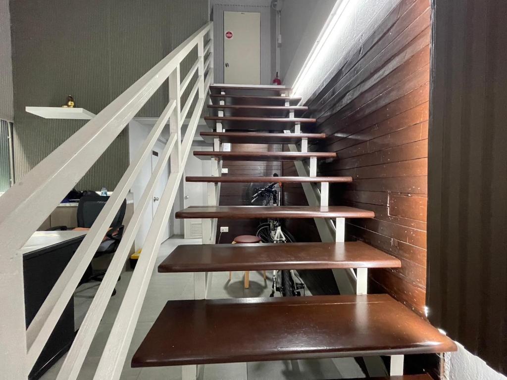 a staircase with wooden benches in a building at Comfort Zone Hostel @ Tha Pae in Chiang Mai