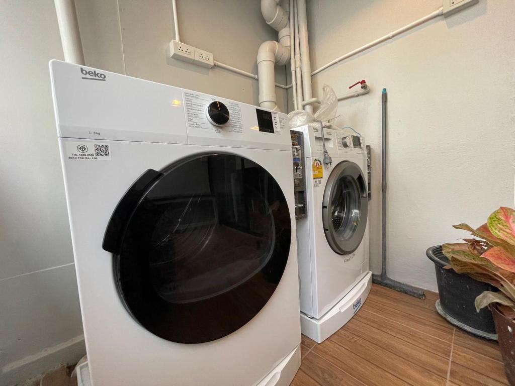 a washing machine is next to a washer at Comfort Zone Hostel @ Tha Pae in Chiang Mai