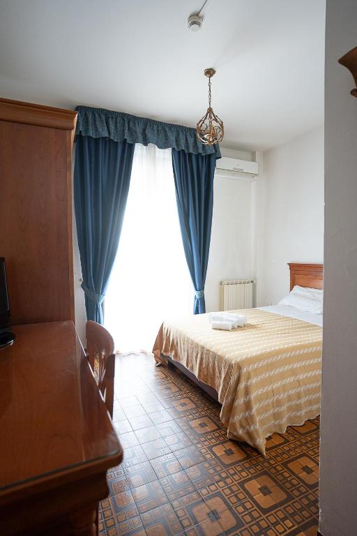 Postel nebo postele na pokoji v ubytování Hotel Napoleon