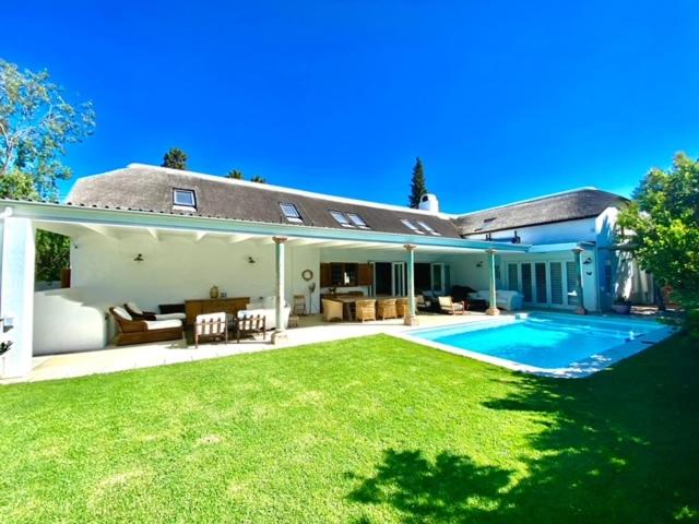 a house with a yard with a swimming pool at The Burrow in Tulbagh