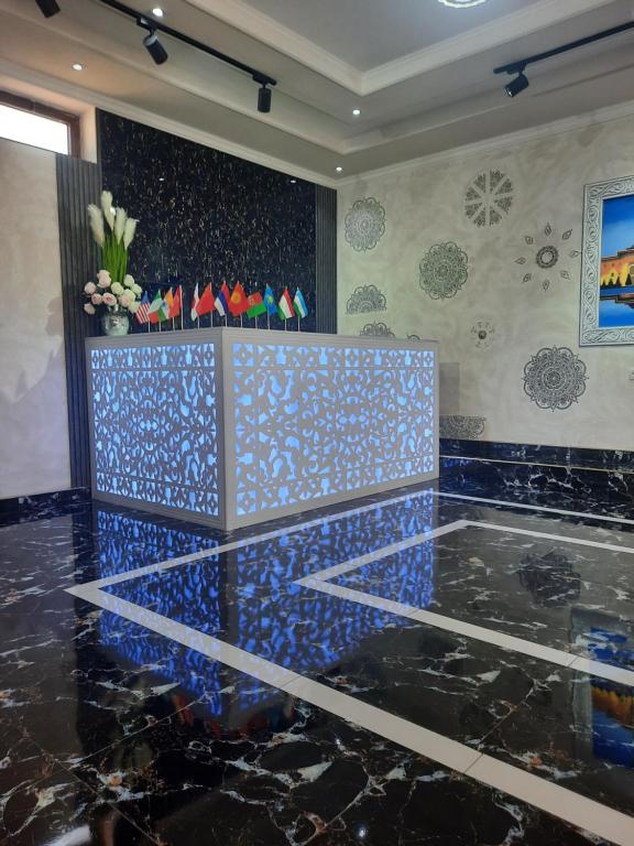 a room with a blue tile floor and a wall at Sam Star of Ulugbek in Samarkand