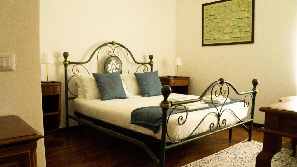 a bedroom with a bed with blue pillows at Delizioso Loft nel Casale con giardino in Olgiata