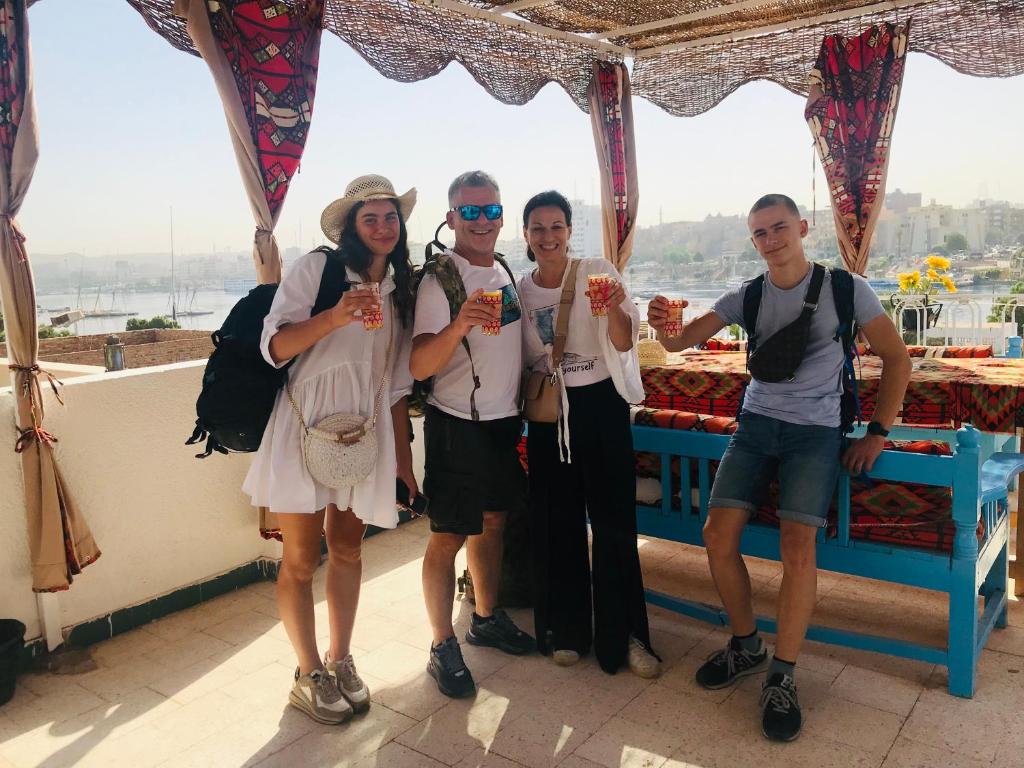 a group of people posing for a picture on a boat at Gamal Robob Nubian Guest House in Aswan