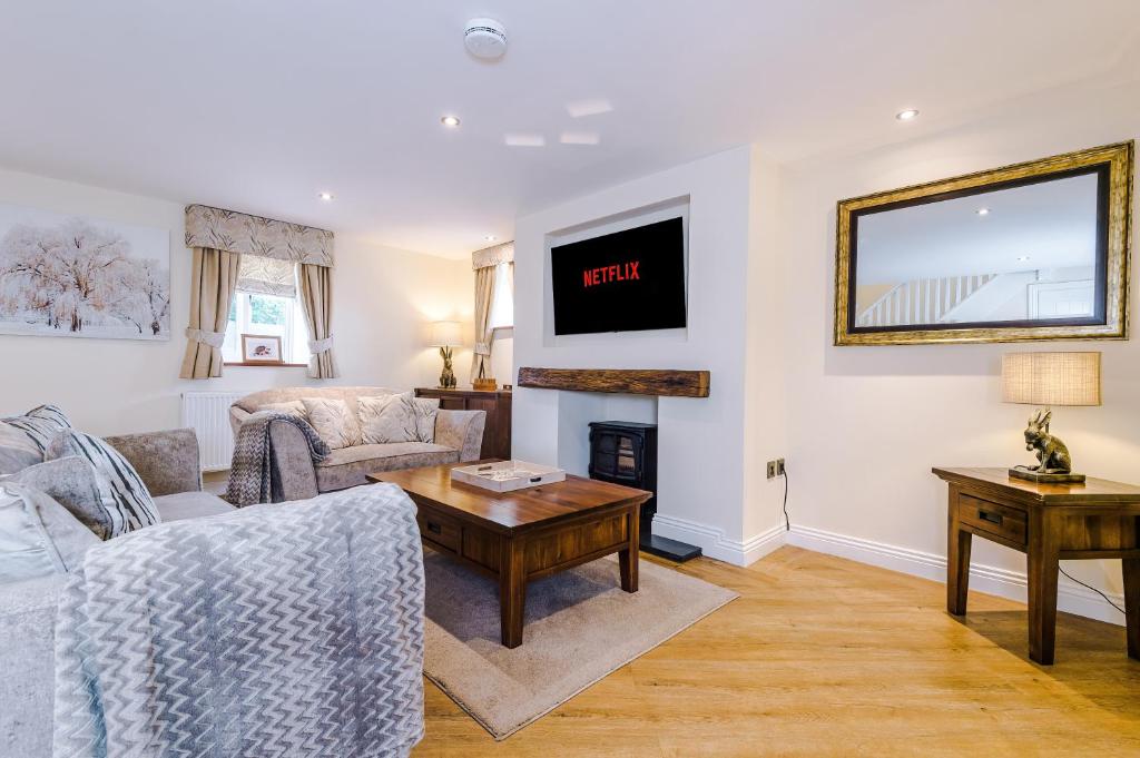 a living room with a couch and a table at Tranquil 1-bed barn in Beeston by 53 Degrees Property, ideal for Couples & Friends, Great Location - Sleeps 2 in Beeston