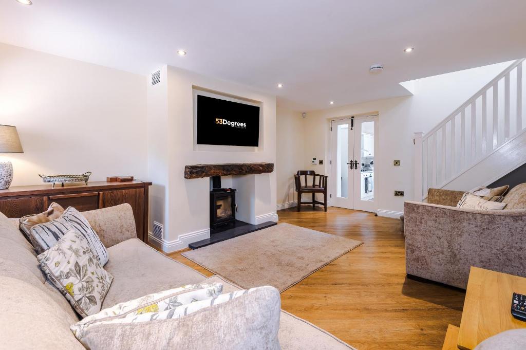 a living room with a couch and a fireplace at Luxurious 3-bed barn in Beeston by 53 Degrees Property, ideal for Families & Groups, Great Location - Sleeps 6 in Beeston