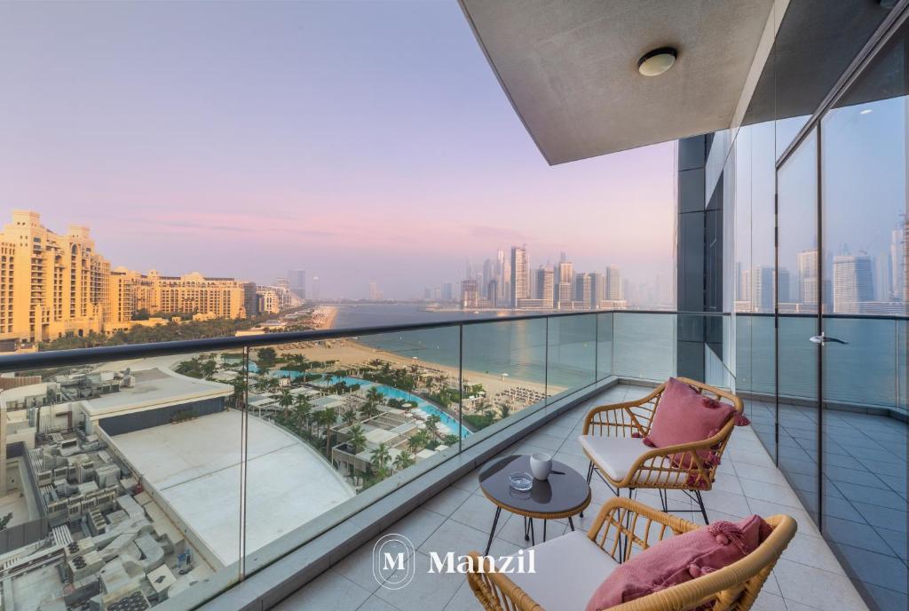 a balcony with a view of the city at Manzil - Stylish 3BR in Palm w Private Beach & Sea View in Dubai