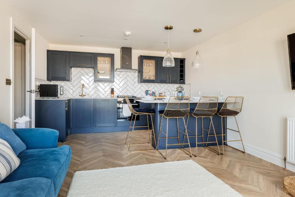 a kitchen with blue cabinets and a blue island at Rockpools in Poole