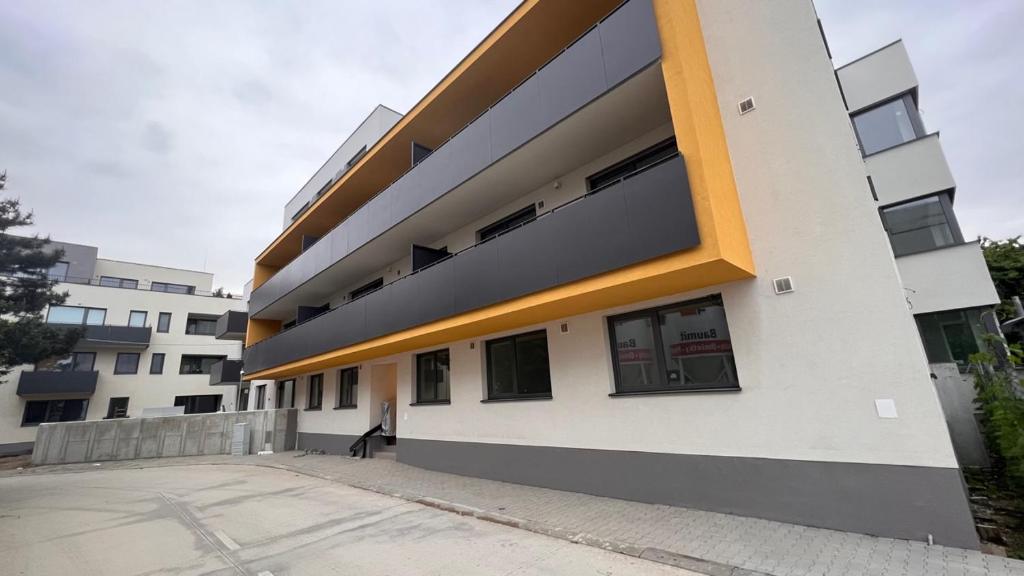 a large white building with a lot of windows at Air-conditioned 2 room Apartment, with terrace, Rovinka, 202 in Rovinka