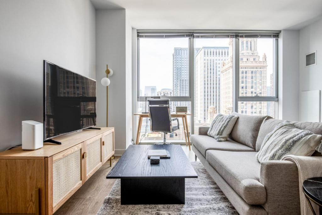 a living room with a couch and a tv at Loop Studio w theater pool nr Millennium Park CHI-958 in Chicago
