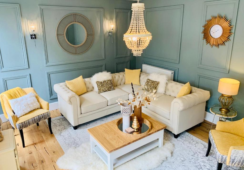 a living room with two couches and a table at Luxury Family Coach House,Riber Castle Views,Easy Walk into Matlock Centre in Matlock