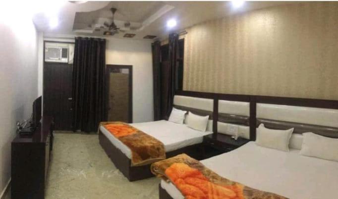 Giường trong phòng chung tại Hotel Maharaja Continental - New Delhi