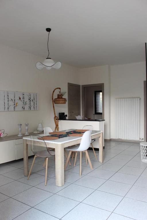 una sala da pranzo con tavolo e sedie in cucina di Casa Maria-Appartamento in Villa a Ispra