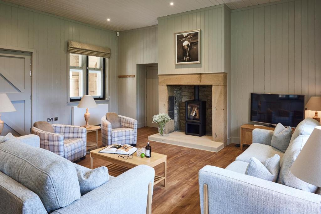 a living room with two couches and a fireplace at The Foal in Hexham