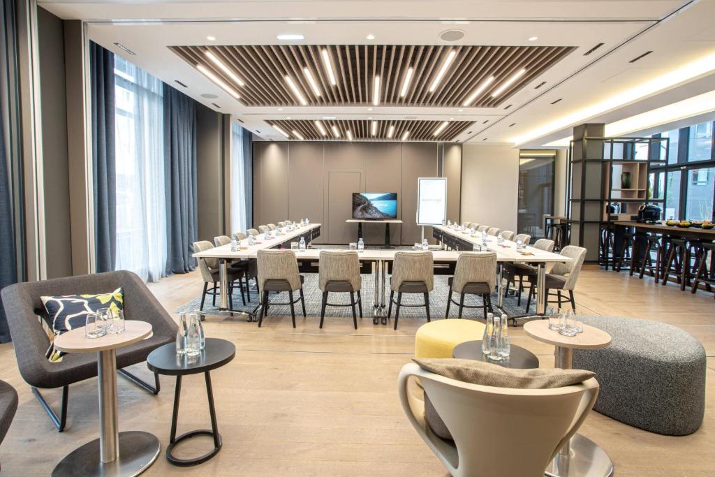 a conference room with tables and chairs and a podium at Courtyard by Marriott Paris Porte de Versailles in Issy-les-Moulineaux