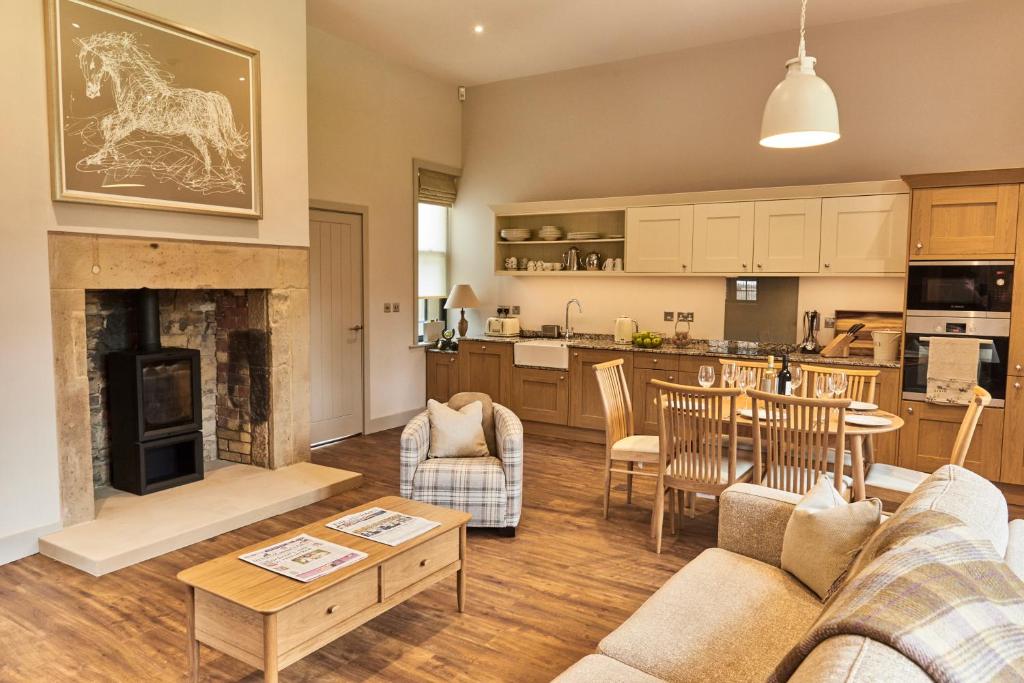 a living room with a couch and a living room with a fireplace at The Stalls in Hexham