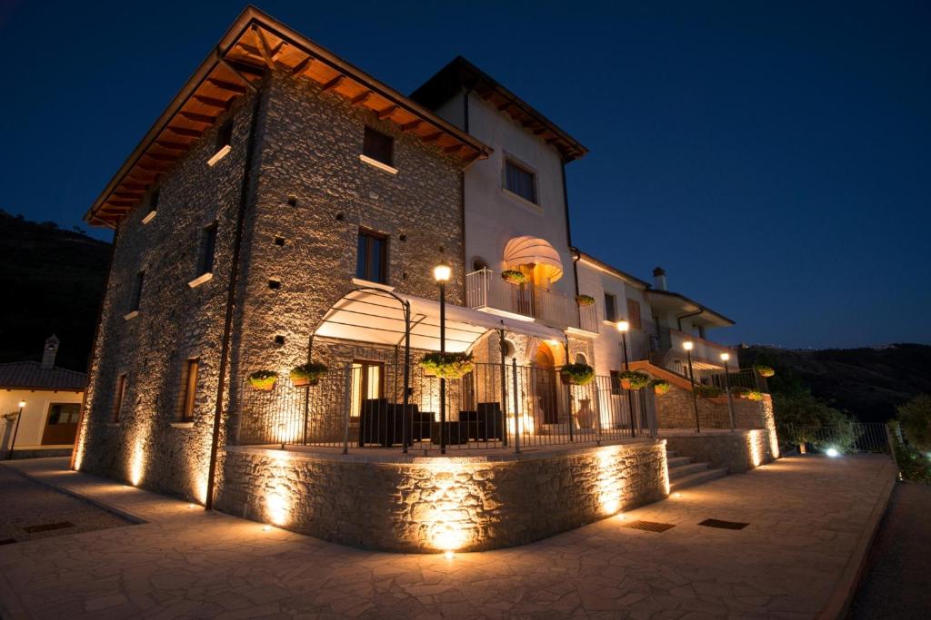 a building with lights in front of it at night at Agriturismo U' Casinu dà Scala in Campora San Giovanni