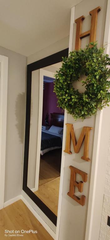a mirror on a wall with a wreath on it at Gasteiz Etxea l in Vitoria-Gasteiz