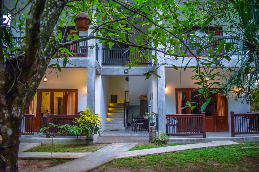 a man standing on the balcony of a house at Lawrence Villa in Weligama