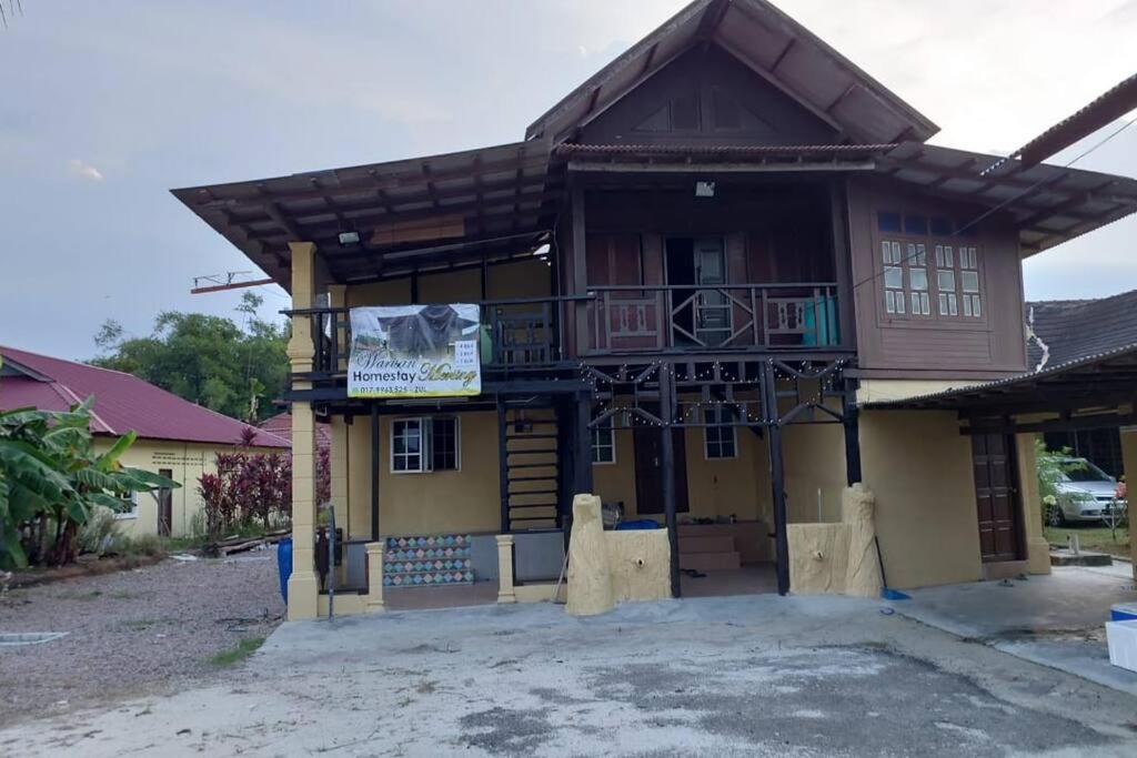 a house with a sign in front of it at Warisan Homestay A in Mersing