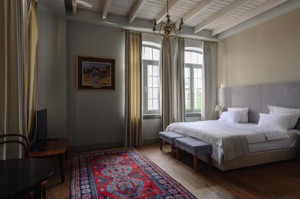a bedroom with a bed and a large window at GRAND HOTEL GYUMRI by APRICOT Hotels in Gyumri