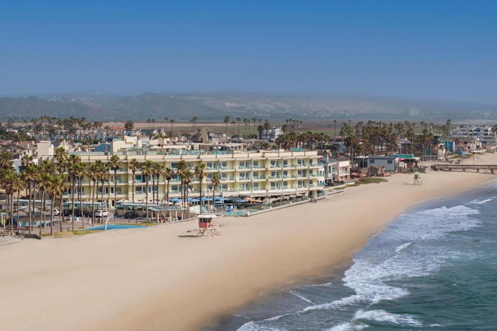 an aerial view of a beach with a hotel at Pier South Resort, Autograph Collection in Imperial Beach