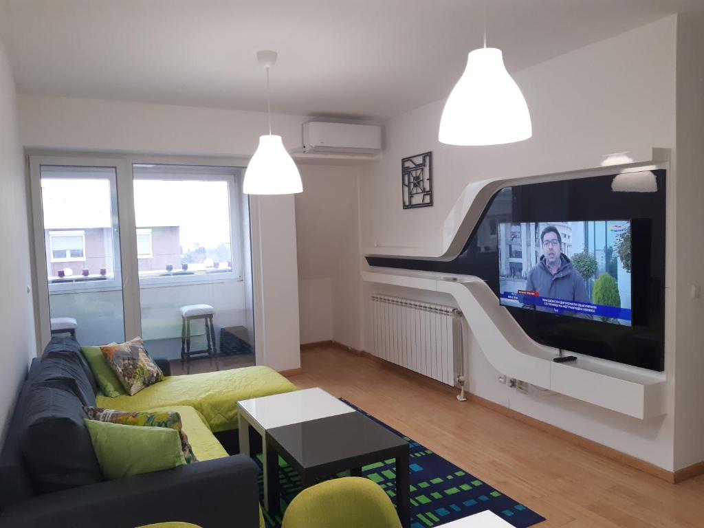 a living room with a couch and a flat screen tv at Moonlight Pent in Skopje