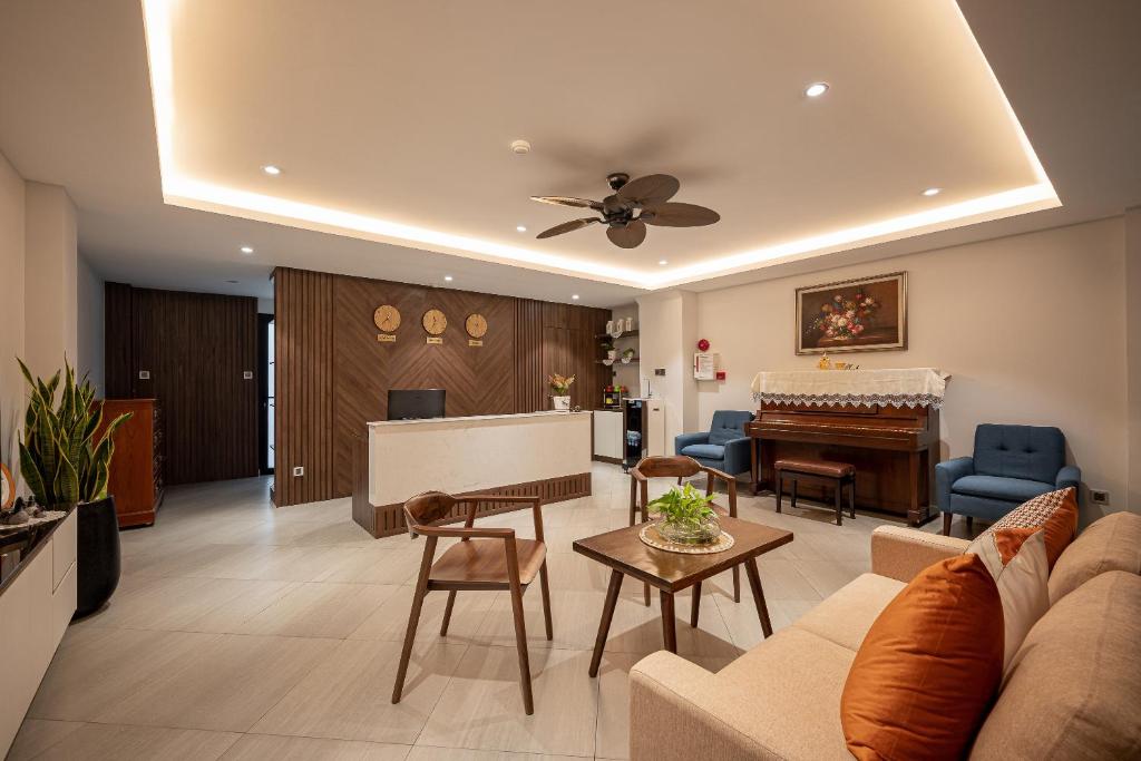 a living room with a couch and a piano at Cozrum Homes - Kena House in Ho Chi Minh City