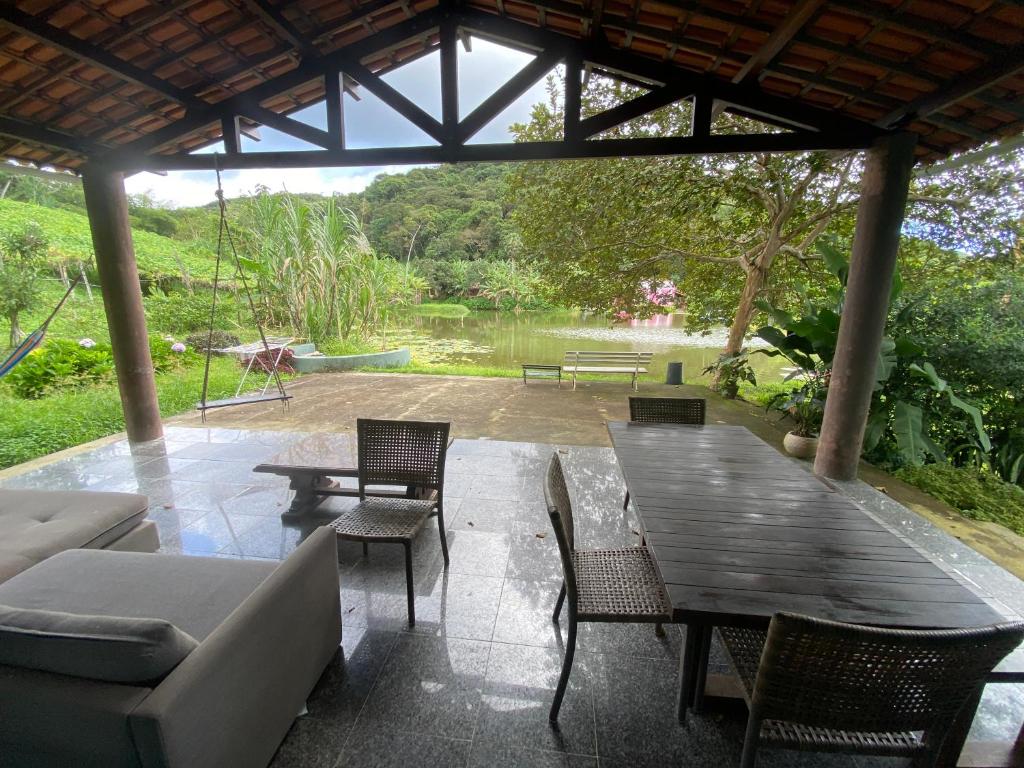 a patio with a wooden table and chairs at Casa Sabia in Pacoti