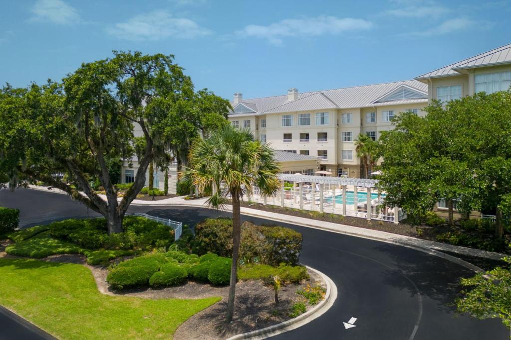 an aerial view of a resort with a pool and trees at Residence Inn Charleston Riverview in Charleston