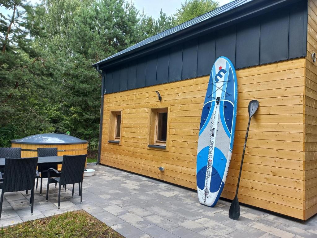 a blue surfboard on the side of a building at Warchały Lake House in Warchały