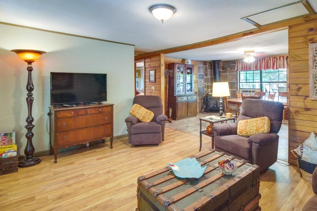 a living room with a television and a couch and chairs at Pet-Friendly Elkins Vacation Rental with Decks! in Elkins
