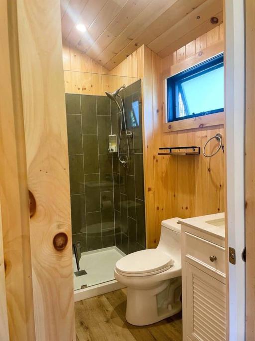 a small bathroom with a toilet and a shower at Vermont Scandinavian Chalet-Courchevel in Wolcott