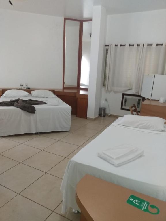 Postel nebo postele na pokoji v ubytování Minas Palace Hotel