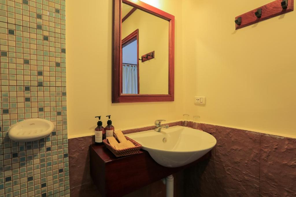 a bathroom with a sink and a mirror at Phongsavath Boutique Hotel in Vientiane