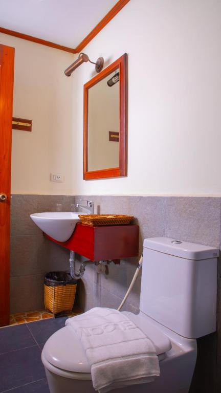 a bathroom with a white toilet and a sink at Phongsavath Boutique Hotel in Vientiane