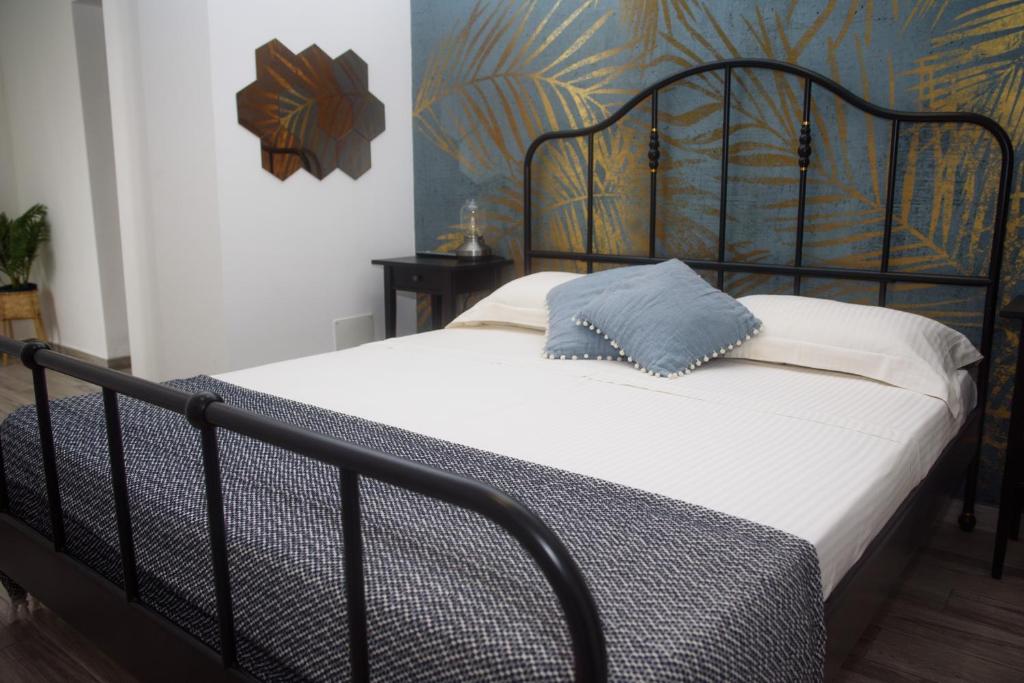 een bed met een blauw kussen erop bij Holiday House ViscaUno in Nettuno