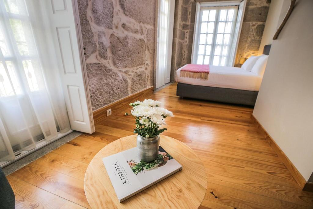 a white vase sitting on top of a wooden floor at My Ribeira Guest House in Porto